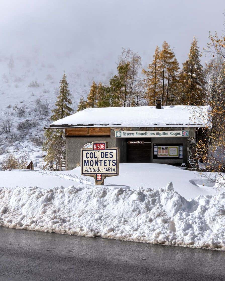 Nature reserve chalet at the Col des Montets, snow still deep beside the road